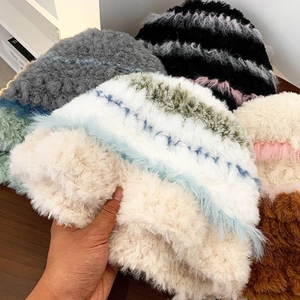 Detailed view of high-gram long-hair plush knit hats in various striped color patterns