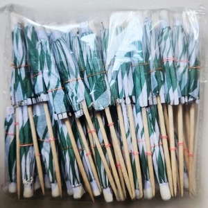 Detail of green and white paper windmill toothpicks for party food and cocktails