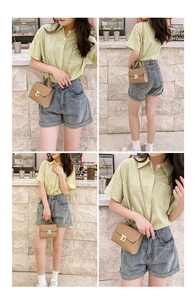 Detail showing khaki small crossbody bag with woven texture and gold metal buckle