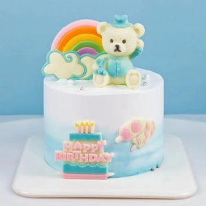 Blue and white gradient cake with bear topper and Happy Birthday silicone mold letters