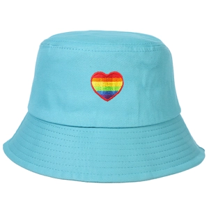 Close-up of a light blue bucket hat featuring a vibrant rainbow heart embroidery detail