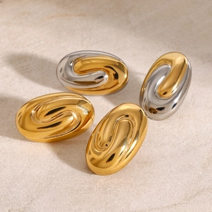 Elegant 18k gold plated stainless steel spiral oval earrings on a stone surface