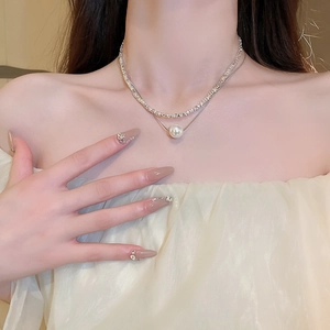 Double-layered silver necklace with sparkling crushed stones and a round pearl pendant