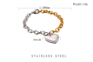 Close-up of dual-tone stainless steel heart pendant bracelet with gold and silver links