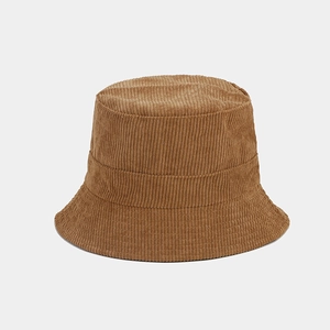 Close-up detail of the brown corduroy fabric texture on a minimalist bucket hat