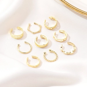 Detail shot of a 9-piece gold-plated U-shaped ear cuff set with various textured patterns