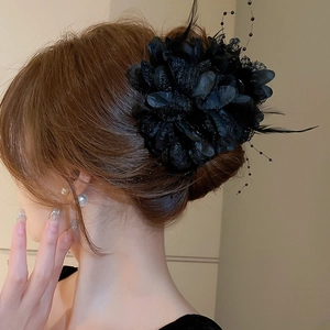 Elegant black lace flower hair claw with feathers and beads for formal hair styling