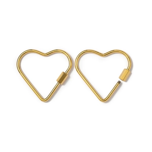 Macro view of gold heart-shaped screw lock carabiners showing open and closed states