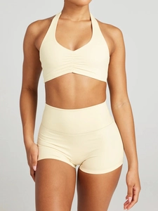 Detail of beige ribbed halter neck sports bra and high waisted shorts yoga set for women