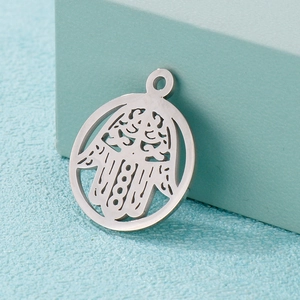 Close-up of stainless steel Hamsa Hand hollow circular pendant for jewelry making