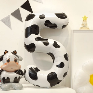 Cow print number 5 foil balloon with a small cow balloon for birthday party decorations