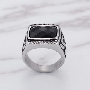 Detailed macro view of silver hip hop ring with black gemstone and vintage textured band