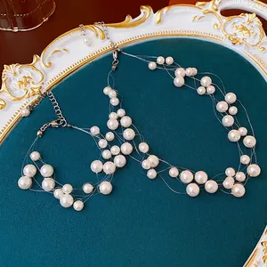 Elegant multi-layered pearl choker necklace with white beads on a velvet jewelry stand