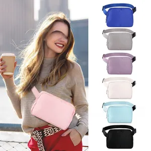 Detail view of multi-color nylon belt bags with adjustable straps and zipper closure