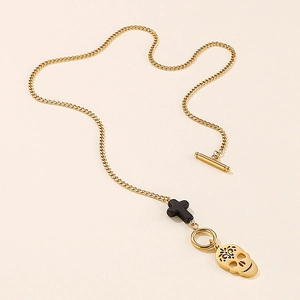 Golden OT clasp necklace with black stone cross and engraved skull head pendants