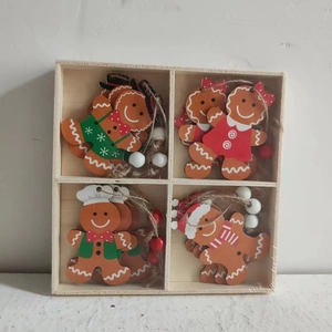 Detailed view of four wooden gingerbread man ornaments with beads in a storage box