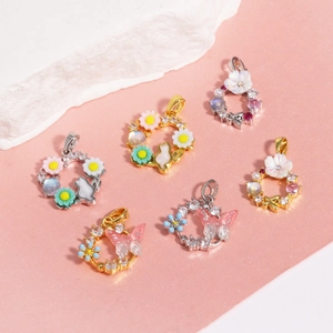 Charming zircon butterfly and floral pendant set with pearls on elegant stone stand