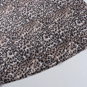 Macro view of leopard print dress hem with high-quality stitching and fabric texture
