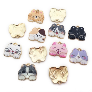 Macro shot of twelve assorted colorful enamel cat charms for DIY jewelry and accessories