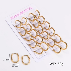 Detailed view of 12 pairs of gold oval stainless steel earrings on a display card