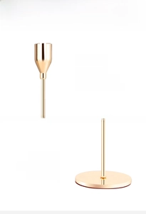 Detailed macro view of the gold plated candle holder with polished finish and detachable base