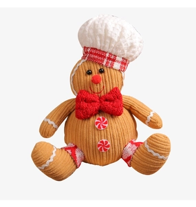 Detailed view of gingerbread man plush toy with corduroy texture and chef hat ornament