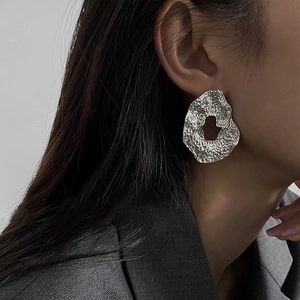 Irregular hollow silver earrings with hammered texture and minimalist geometric design
