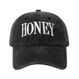 Faded black washed cotton baseball cap with white HONEY letter embroidery