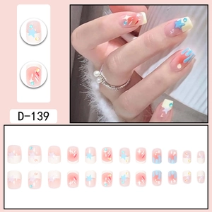 Star and rainbow gradient press-on nail kit with pink base and blue stars decor