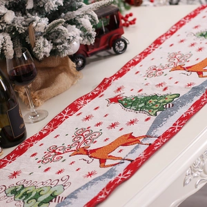 Knitted Christmas table runner with tassels featuring reindeer and snowflake patterns