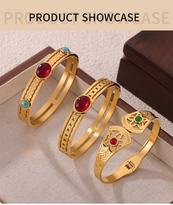 Detailed view of vintage gold plated steel bangles with turquoise and ruby gemstones