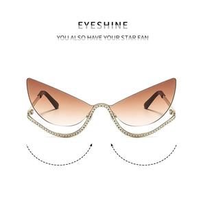 Detail of cat-eye sunglasses with gradient brown lenses and sparkling rhinestone trim