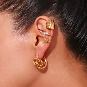 Close-up of 18K gold-plated stainless steel hoop and pearl ear cuff set on model
