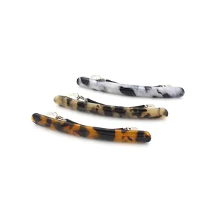 Three acetate hair clips with leopard and tortoiseshell patterns on a white background