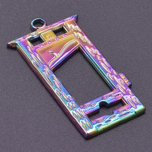 Macro shot of guillotine-shaped stainless steel pendant with rainbow plating