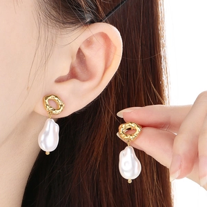 French style gold baroque pearl earrings featuring irregular textured metal circles