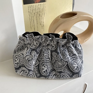 Elegant paisley embroidered clutch bag in grey and white with a white pearl clasp closure