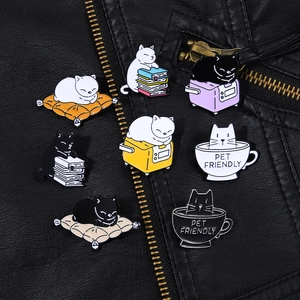 Set of 8 cute cat enamel pins on black leather jacket featuring diverse feline poses