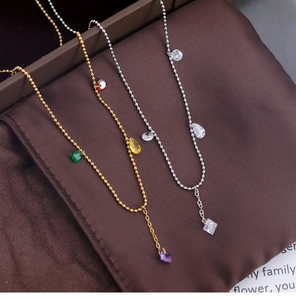 Detailed close-up of colorful crystal pendants on gold and silver beaded necklaces