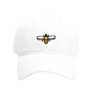 Close-up of a small bee embroidery on a white cotton washed baseball cap with fine texture