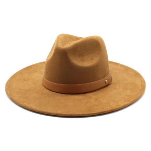 Detail of camel wool fedora with leather band and gold metal rivet on white background