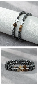 Close-up of black hematite beaded bracelet set with cross and wood details