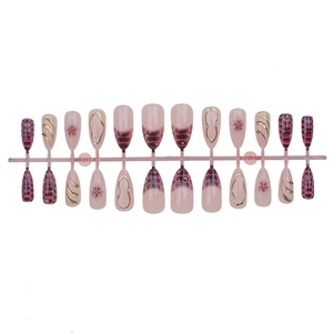 Set of 24 almond press-on nails featuring red marble patterns and floral gold accents