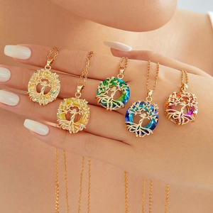 Detailed view of tree of life necklaces in five colors with gold plating on a hand