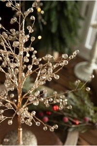 Macro detail of champagne gold branches with faceted crystal beads for Christmas decor