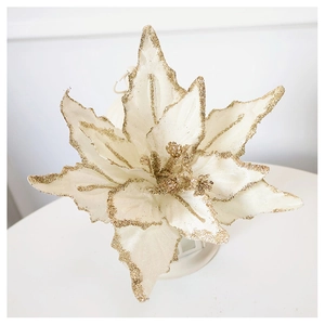 Detail of cream velvet Christmas flower with sparkling gold glitter edges on petals