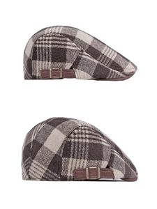 Detail of vintage plaid newsboy cap featuring corduroy side strap and bronze metal buckle