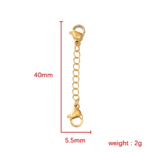 Macro detail of 40mm golden stainless steel extender chain with dual lobster clasps