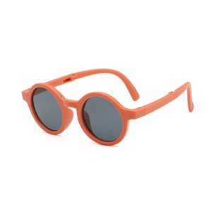 Foldable orange round frame kids sunglasses with UV protection and dark grey lenses