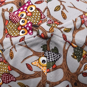 Macro view of owl print pattern and stitching on fabric crown of this baseball cap